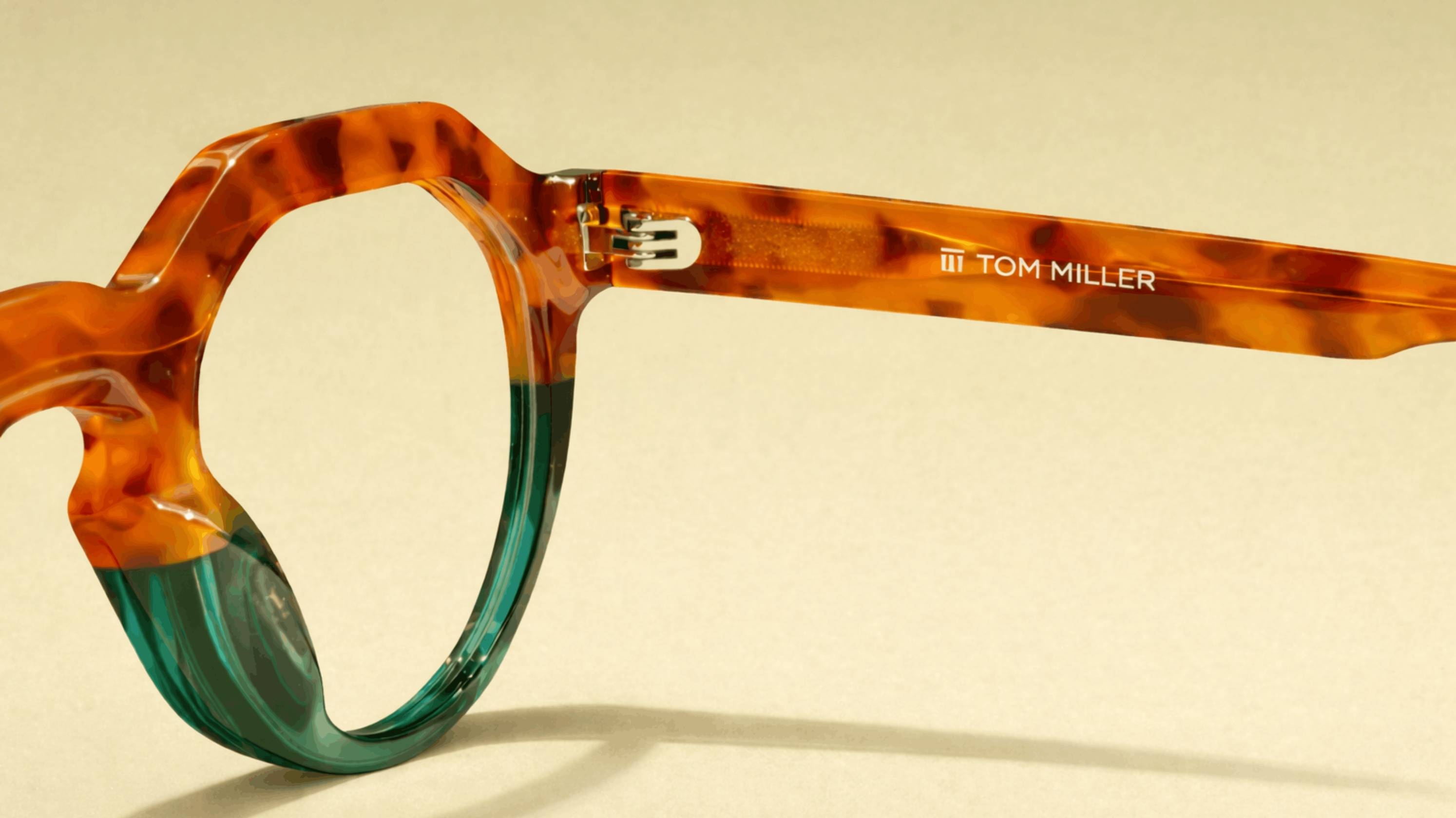 Close-up of handcrafted luxury eyewear frame showing intricate temple detail and premium acetate material